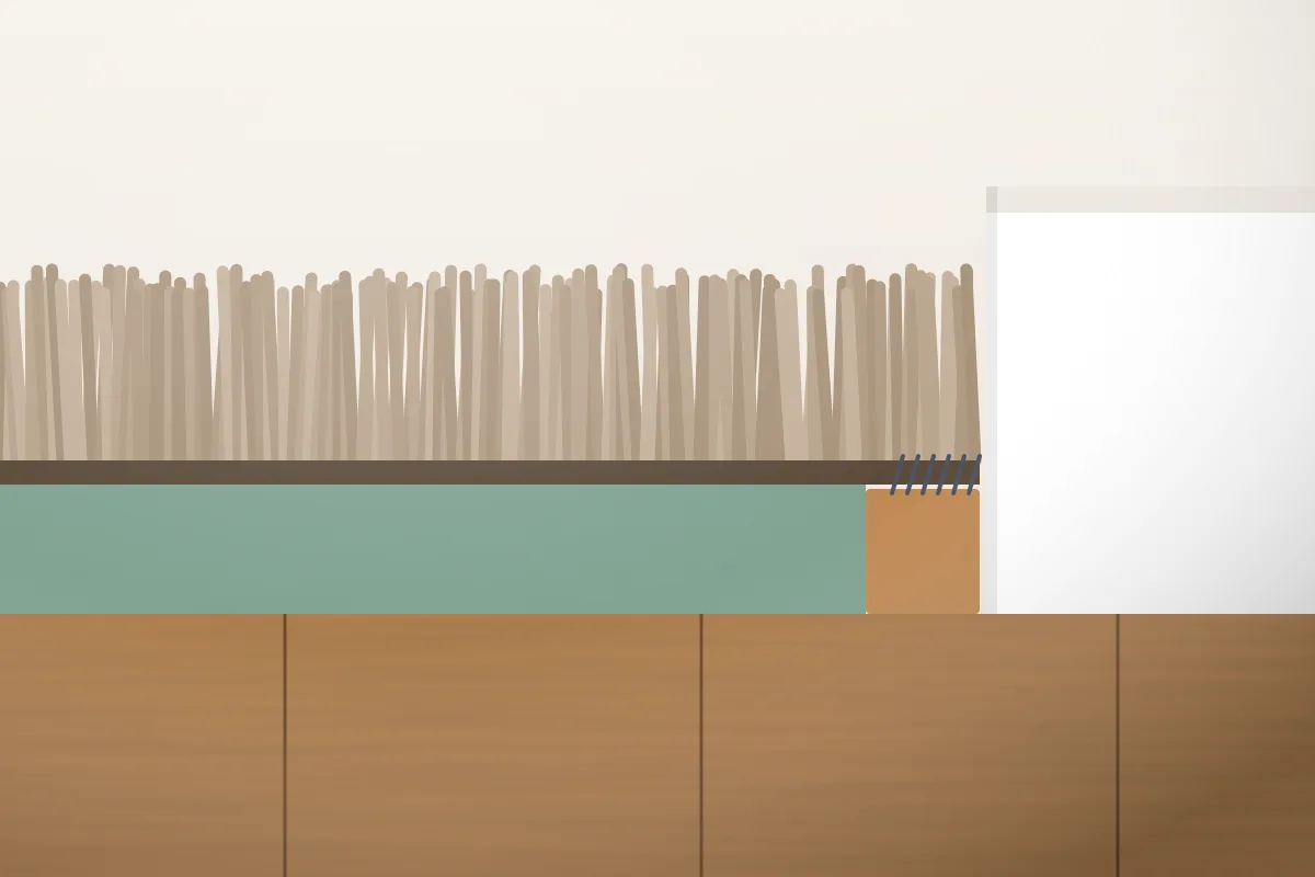 Illustration of a fitted carpet in cross-section: pile, backing, foam underlay and a gripper strip against the skirting board